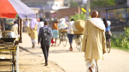 Old indian man walking down the street - Powered by Adobe