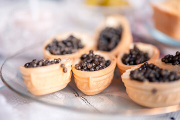 Waffle Tartlets With Black Caviar And Cream Cheese On A Glass Plate. Home Holiday. Festive Serving. Close Up. Selective Focus. Macro.