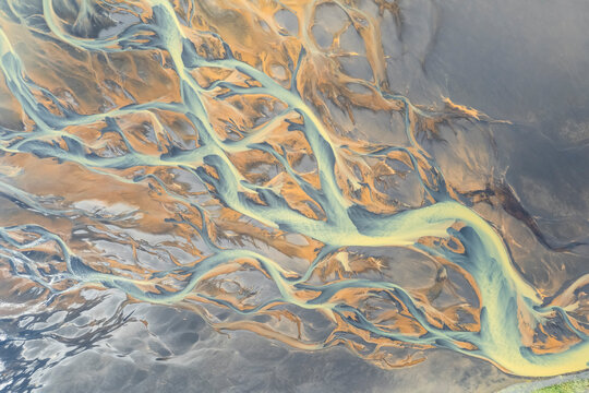 Aerial view of a water abstract pattern from a river estuary in Iceland.