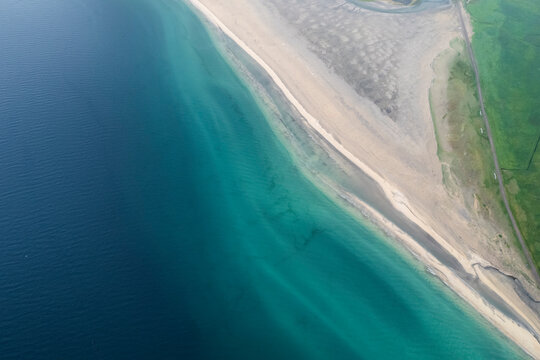 Aerial view of the beautiful coastline with high cliffs and mountain at sunset, Westfjords.