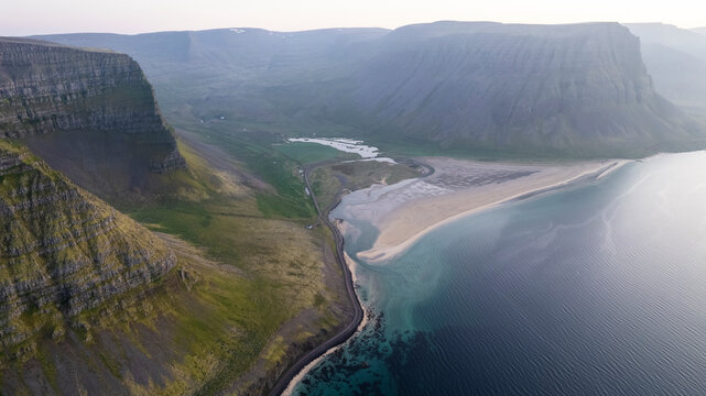 Aerial view of the beautiful coastline with high cliffs and mountain at sunset, Westfjords.