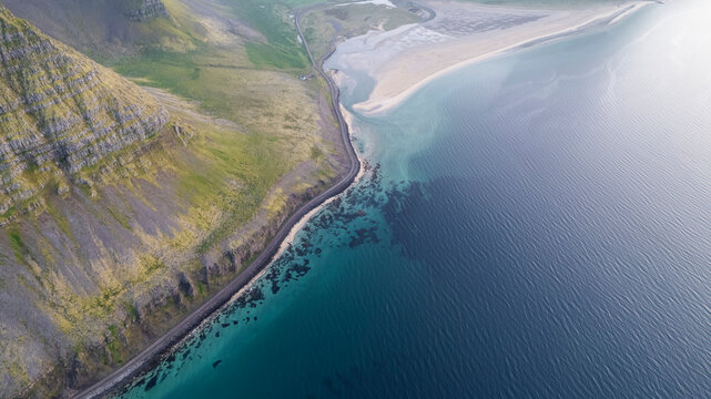 Aerial view of the beautiful coastline with high cliffs and mountain at sunset, Westfjords.