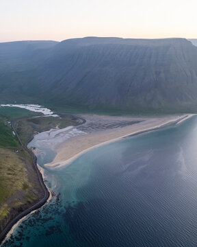 Aerial view of the beautiful coastline with high cliffs and mountain at sunset, Westfjords.