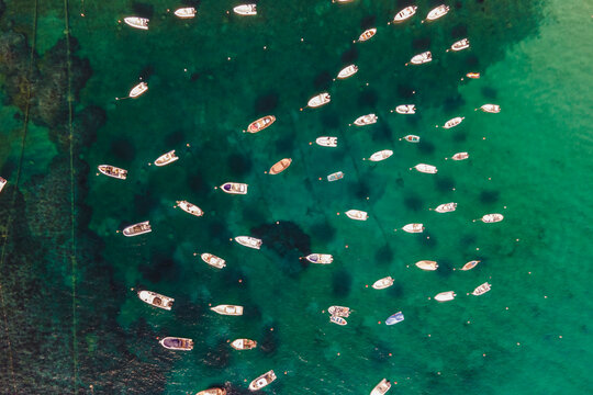 Aerial view of sailing and fishing boats docked in a small bay in Procchio near Marciana Marina, Elba Island, Italy.