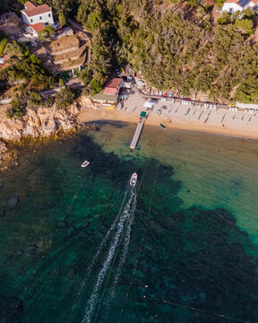 Aerial view of a motorboat along the coast in Procchio, Elba Island, Italy.