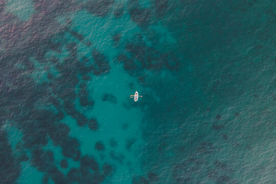 Aerial view of a small boat along the coast in Pomonte, Elba Island, Tuscany, Italy.