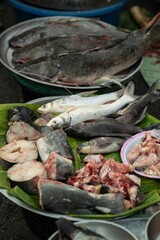 Animal products for cooking are sold at the street food market. Fresh fish meat is a popular traditional Thai food in the morning market..