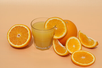 fresh bright orange juice with oranges on yellow background