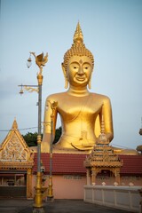Large outdoor golden sitting Buddha is Phra Phuttha Ket Mongkhon enshrined at Wat Thewaprasat. Which can be clearly seen from afar Because it is located on the River and is a famous peace.
