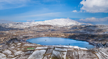 Aerial view of Lake Ram in wintertime with snow, Golan Heights, Israel.
