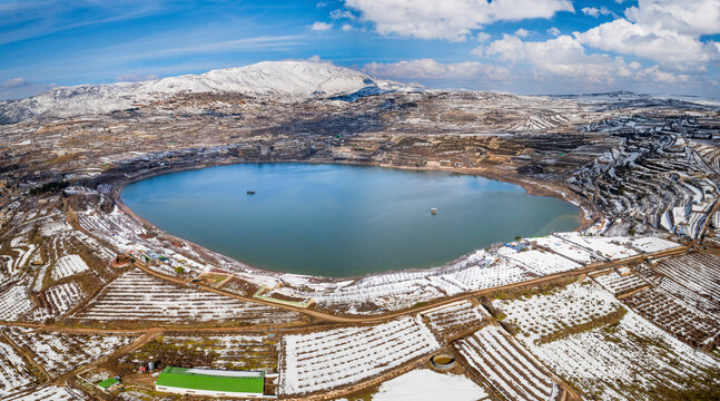 Aerial view of Lake Ram in wintertime with snow, Golan Heights, Israel.