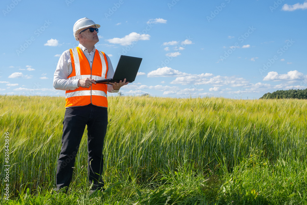 Aufkleber architect with laptop. man architect on background of grass and sky. employee architectural bureau i