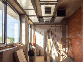 Construction and repair. Unfinished building inside view. Room without finishing. Small room with central air conditioning. Construction services concept. Unfinished room with window and brick walls