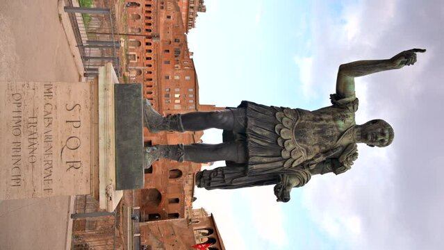 Statue of Augustus Caesar with ancient buildings on the background in Rome, Italy