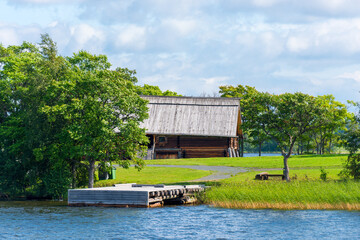 Central Russian landscape with wooden buildings near the river