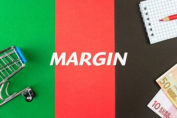 MARGIN - word (text) and euro money on a table of different colors, a trolley, a basket of grocery notepad and a red pencil. Business concept, buying, selling, supermarket, store (copy space).