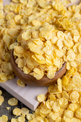dry breakfast corn flakes of yellow color , close up