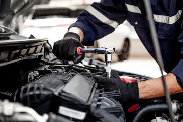Car care maintenance and servicing, Close-up hand technician auto mechanic using the wrench to repairing change spare part car engine problem and insurance service support.