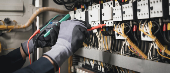 Electricity and electrical maintenance service, Engineer hand holding AC multimeter checking...