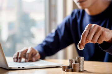Man hands putting coins stack, Concept business finance saving money and investment.