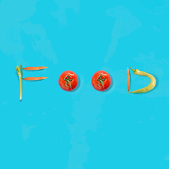 Creative vegetable pattern made of tomato, carrot, onion and green chilli pepper on bright blue background. Vegetable font idea, healthy eating concept.