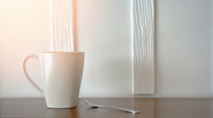 coffee cup and spoon on table bar in the morning