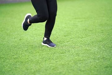 woman runner running with sport shoe in backyard lawn grass