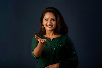 Young beautiful girl on gray background afraid and shocked with surprise and amazed expression, fear and excited face.