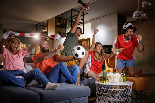 Friends watching football celebrating their team victory