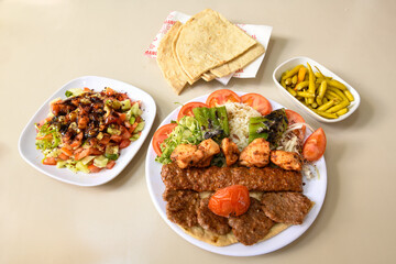 Beef steak grill with rice pilaf, fried potatoes, grilled pepper and tomatoes.Mix Platter with Beef rips, Cutlets, Potatoes and Sauces.