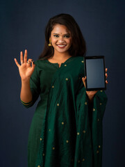 Young beautiful girl showing a blank screen of smartphone or mobile or tablet phone