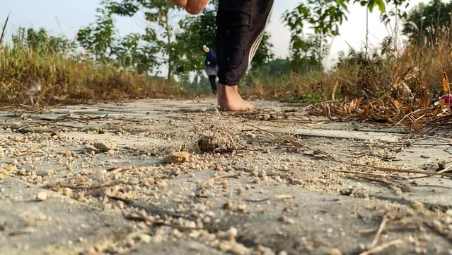 Injury risks, barefoot running on gravel, thorny roads. clip for footwear product promotion, health isues.  