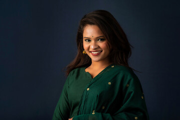 Portrait of a young girl or woman posing on gray background