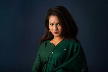 Portrait of a young girl or woman posing on gray background