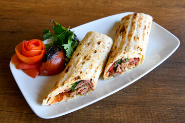 Lavash doner kebab ( zurna tavuk et doner durum )  or shawarma sliced in plate isolated. 