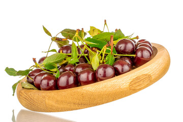 Several ripe cherries on a wooden plate, close-up, isolated on a white background.