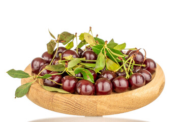 Several ripe cherries on a wooden plate, close-up, isolated on a white background.