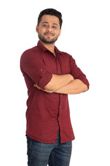 Portrait of a happy young man posing with arms crossed or hands folded on a white background