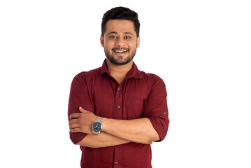 Portrait of a happy young man posing with arms crossed or hands folded on a white background