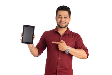 Young handsome man, businessman showing a blank screen of a smartphone or mobile or tablet phone on white background