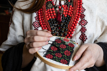 A girl embroiders a traditional Ukrainian vyshyvanka pattern - 521661871
