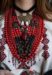A girl embroiders a traditional Ukrainian vyshyvanka pattern - 521661873
