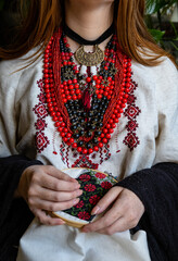A girl embroiders a traditional Ukrainian vyshyvanka pattern - 521661875