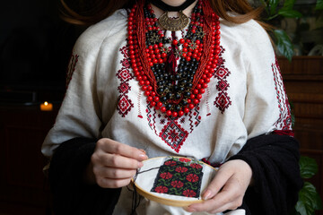 A girl embroiders a traditional Ukrainian vyshyvanka pattern