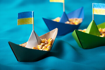 Ships with Ukrainian maize grain made of paper concept