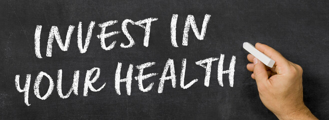  Text written on a blackboard -  Invest in your health
