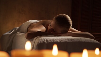 Young, healthy and beautiful woman gets massage therapy in the spa salon. Healthy lifestyle and...