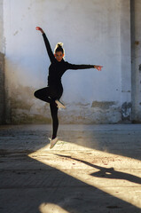 Ballerina jumping and dancing in an abandoned building on a sunny day © Solid photos