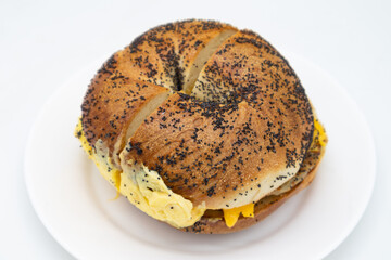New York City Style Poppy Seed Bagel Filled with Eggs Cheese and Sausage
