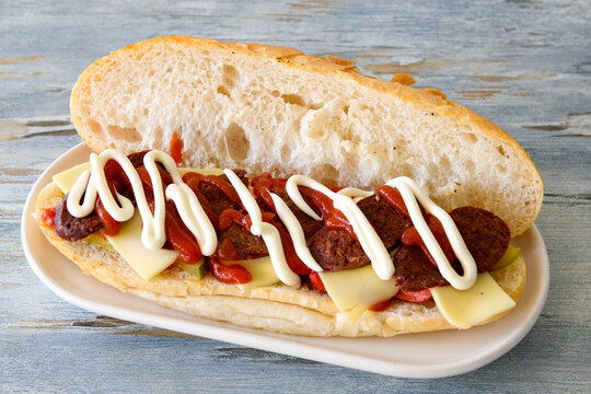 Close-up shot of Izmir's famous Turkish Traditional Kumru Sandwich, Ceşme Kumru, patso ingredients ready to eat salami, soudjouk, tomato, cheddar cheese and fried cheese. Yengen sandvic.